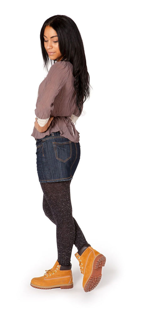 Full-length side view of short, indigo, medium weight denim skirt with clear sight of back pockets and belt loops