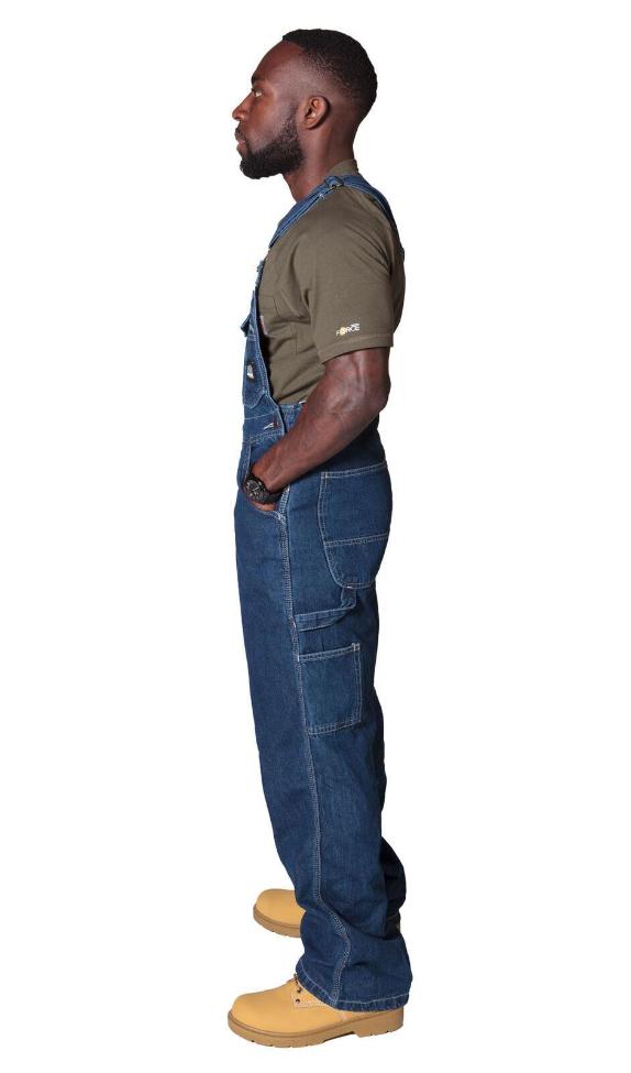 Full side pose wearing work dungarees showing side button fastening.