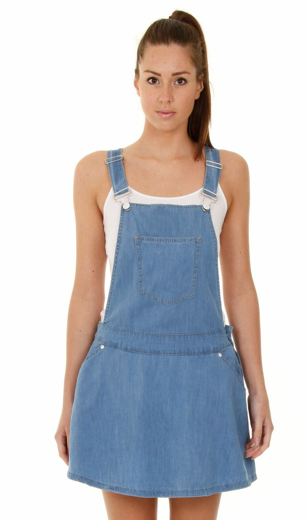 Close-up front view of mini dungaree skater dress with view of adjustable straps and front pockets.