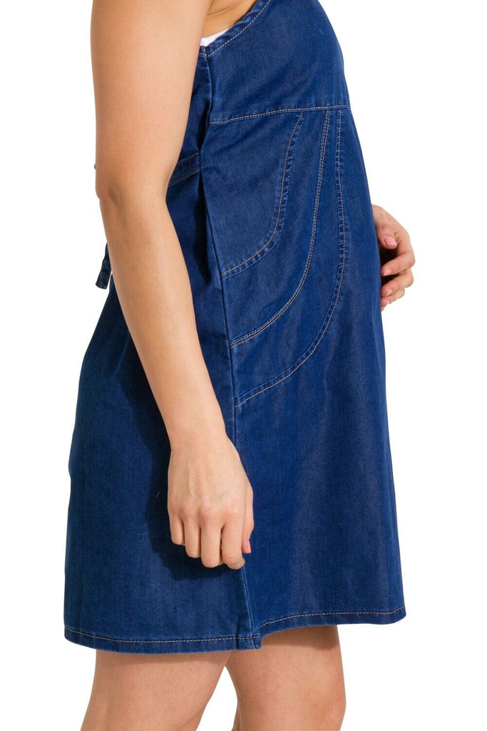 Close-up side view of Thelma denim maternity dress showing bump and stretchy fabric properties.
