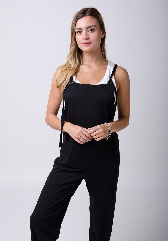 Two-thirds pose wearing Mabel style practical black jumpsuit.